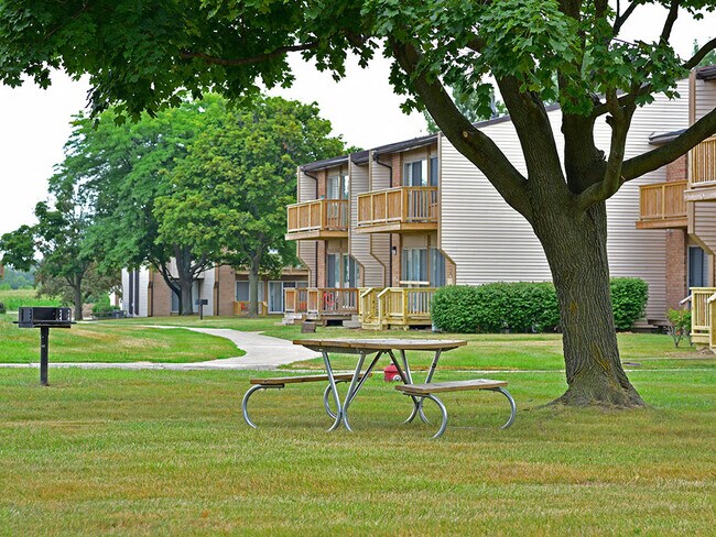 A picnic table and grill at Grand Bend Club Apartments