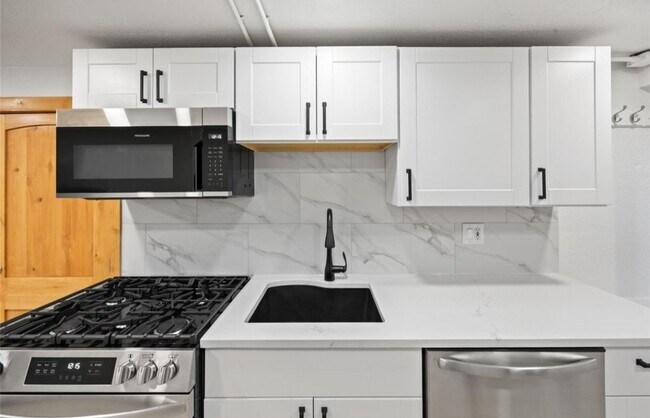 Brand new kitchen with quartz countertops and gas range/oven