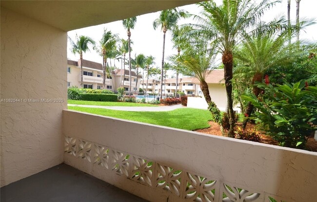 Lush landscaping with pool view from the living room and porch - 14500 SW 88th Ave Unit Villagio at Palmetto