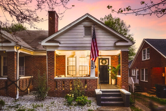 Charming brick home with a welcoming front porch, perfect for enjoying beautiful sunsets - 715 Grandin Rd