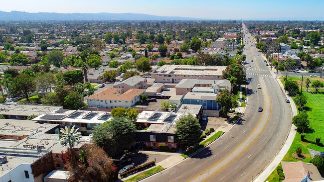 Aerial drone photo of 10620 NoHo showing solar panels and energy-efficient white roofing.