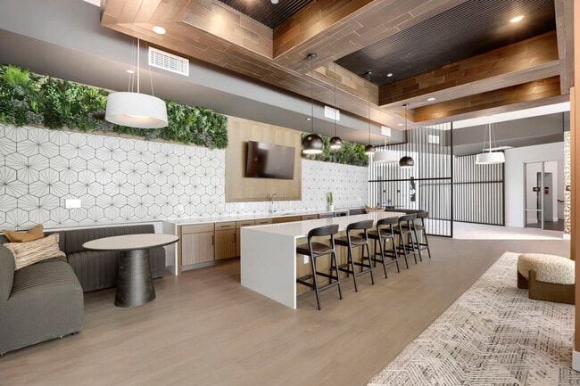The social hub of Garrett Uptown. Our clubhouse kitchen and lounge features a full quartz-topped island, bar seating, a greenery wall, and a mounted TV, making it the perfect spot for watching the game or hosting neighbors.