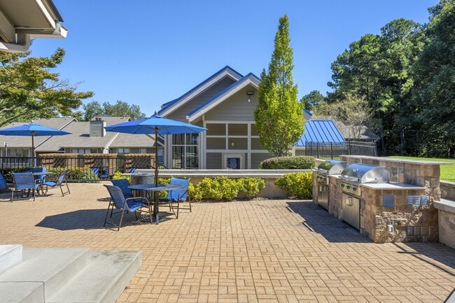 Outdoor entertainment space that's outfitted with a grilling station and abundant seating.