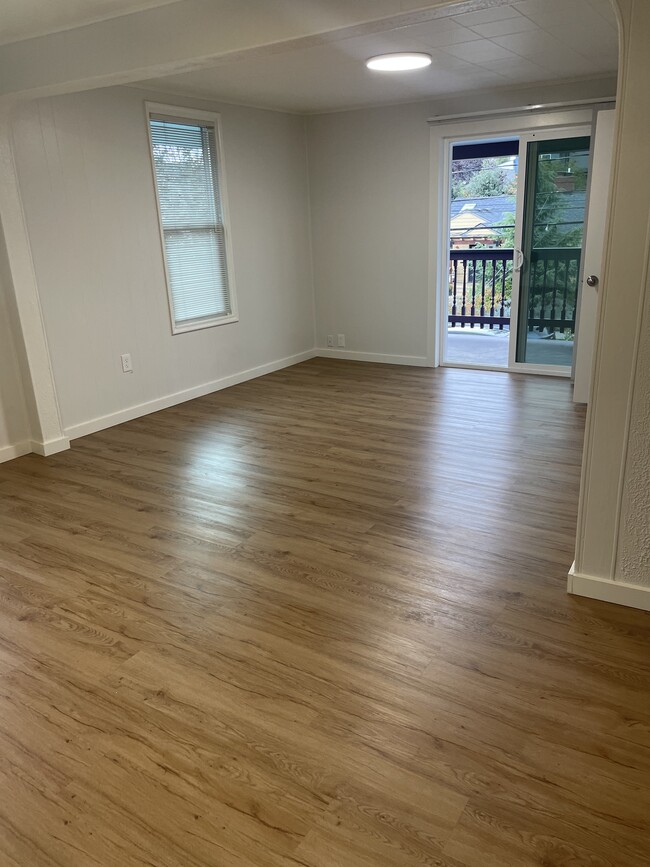 Living room/dining room looking out onto porch - 1111 NW 58th St Apartments Unit #A Upper Floor