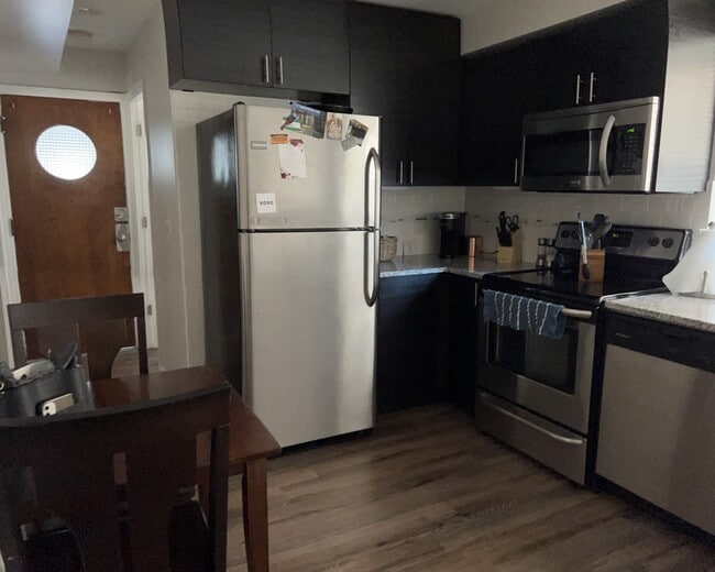 Kitchen with SS appliances and granite counter - 6626 W Devon Ave Unit 1