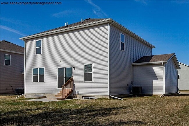 Photo - "Ankeny Oasis: Luxurious 4-Bedroom Home with Expansive 3-Car Garage and Secluded Backyard Retreat!"