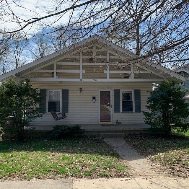 covered front porch with swing - 210 E Vermilya Ave