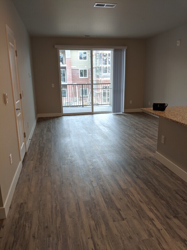 Open concept from kitchen to living area - 14341 E Tennessee Ave Unit 204