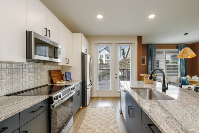 Modern kitchens with granite counters and stainless steel appliances