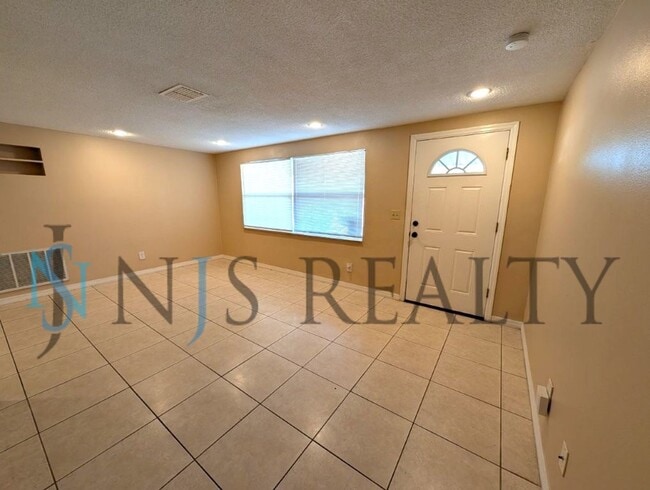 Photo - This 3/2/1 with over 1100 sq ft offers all tile floors open kitchen/dining, split floor plan on a...
