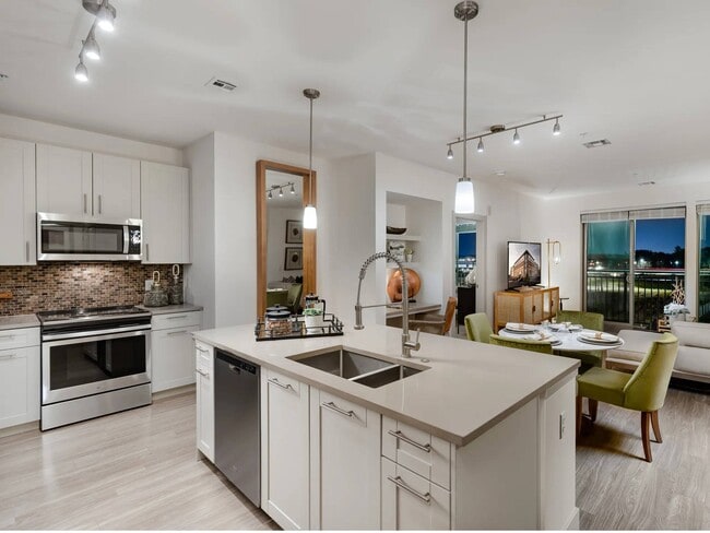 A kitchen island here keeps the sink clear of the main cooking wall.