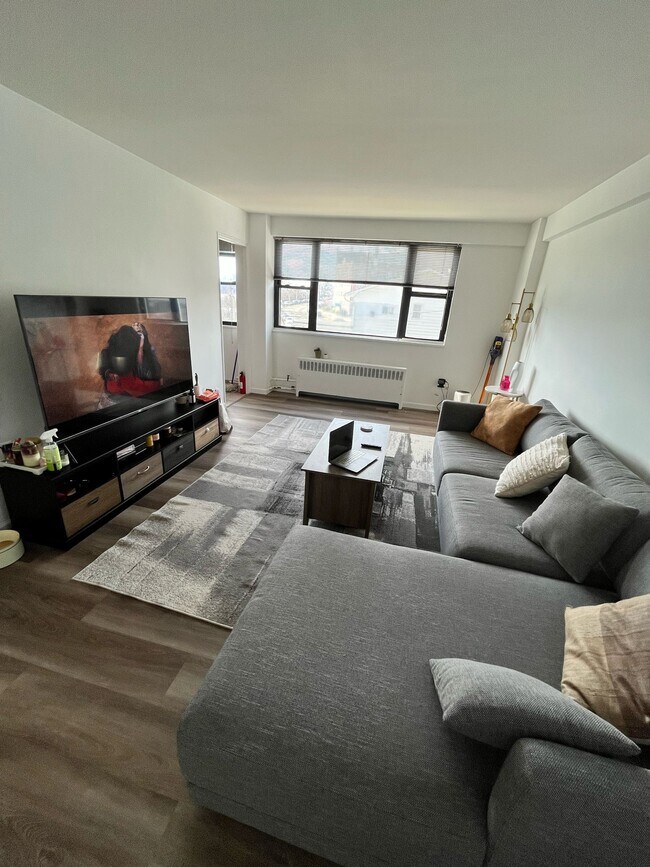 Living room with NYC view - 6515 Boulevard E Unit 1P