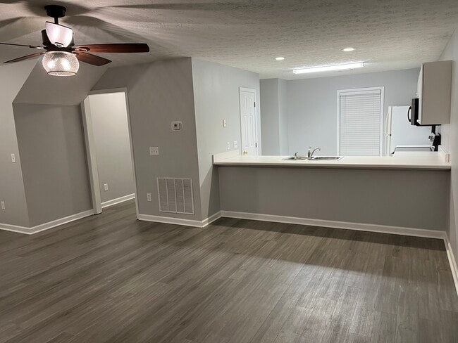 Living facing kitchen - 1477 N Donahue Dr