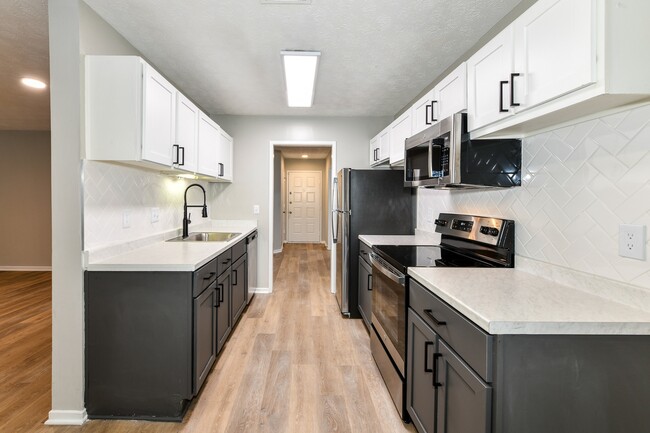 Kitchen with two-toned cabinets - Avana Chase Apartments