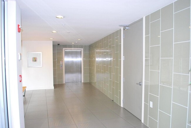 Lobby / elevator and door to garage - 1310 Creekside Dr Unit 203