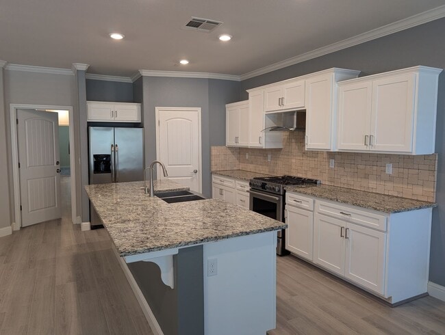Photo - Modern 5 bedroom 3 bathroom home in the Riverstone Community offering solar, In-laws suite, den o...
