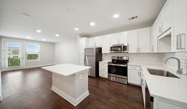 New kitchens with stainless steel appliances and white quartz countertops - 21 Fitzsimons Apartments