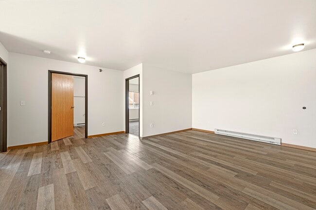 Step into the inviting open layout of Paramount at the Bluffs Apartments, featuring modern finishes and abundant natural light. This spacious living area is perfect for your personal touch. Schedule a tour today to envision your new home!