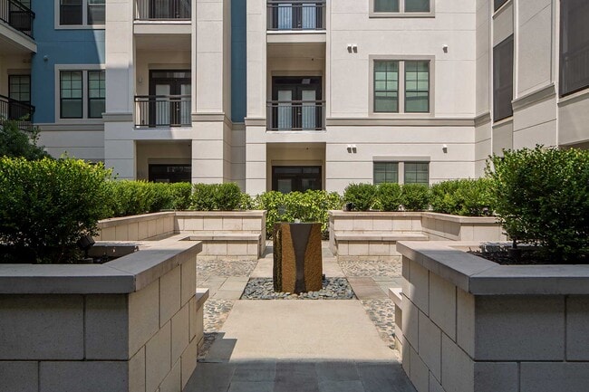 Decorative fountain with stone bench seating around