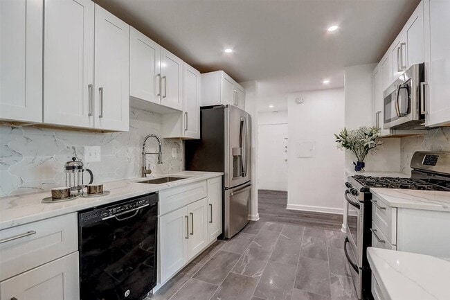 Gorgeous remodeled kitchen - quartz countertop, marble backsplash, extra large refrigerator/freezer. - 240 M St SW Unit E100