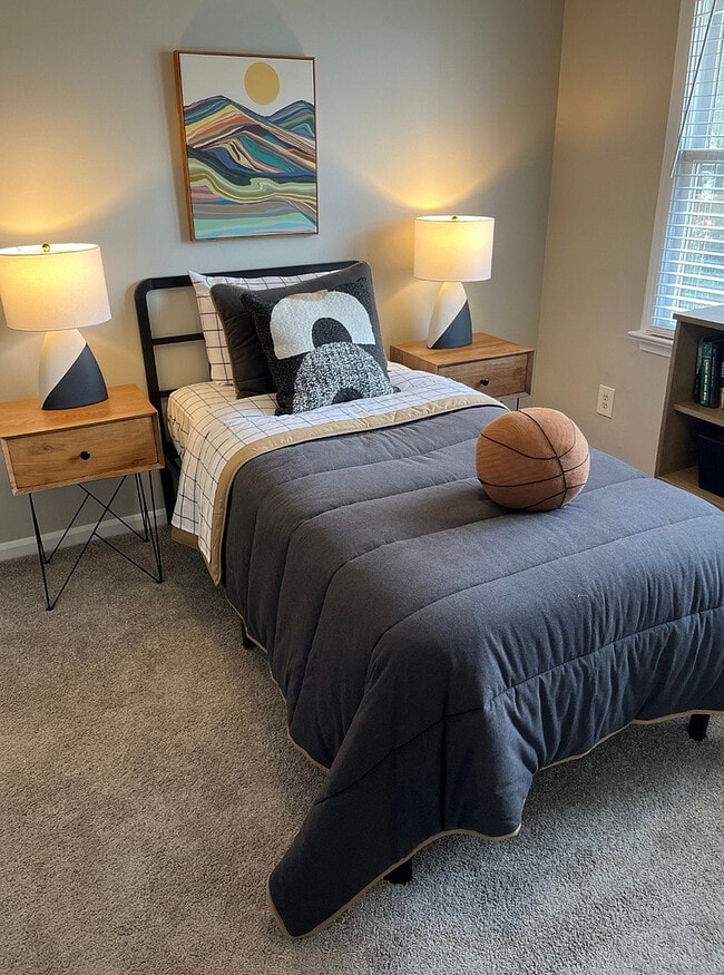 A spacious bedroom with room for both rest and a dedicated work area.