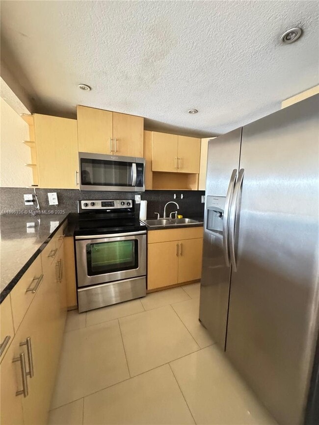 Building Photo - 6095 W 19th Ave Unit 407