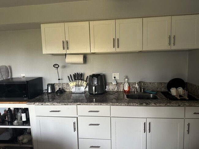 bar area with cabinetary and sink - 2300 Sunset Heights Dr Unit david younesi