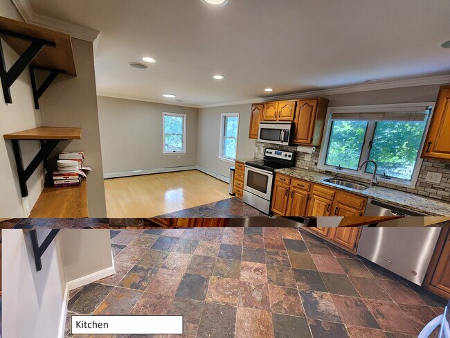 Kitchen w/ slate floor and stainless appliances. Opens into dining room. - 68 Peach Orchard Rd