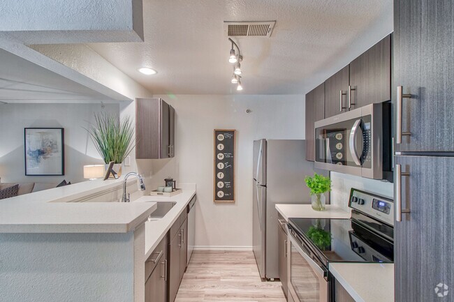 Kitchen with Espresso Cabinetry and Stainless Steel Appliances - Stonelake at the Arboretum Rental