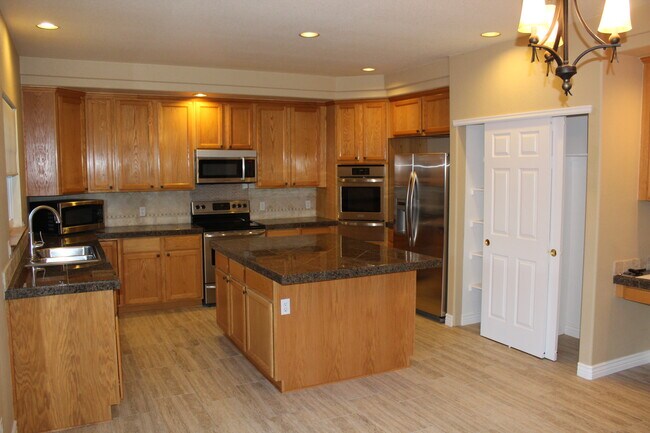 Kitchen – sunny/bright, large granite island, french doors to large deck - 2720 South Cole Court