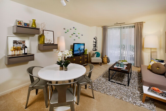 Classic Package living and dining area with carpeted floor and balcony