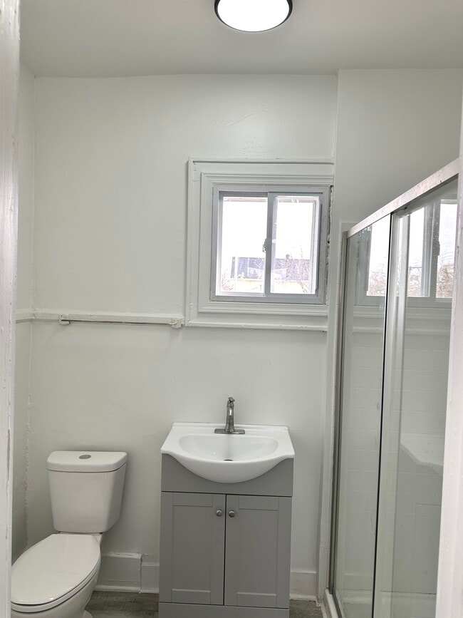 Modern Bathroom w/ sliding glass shower doors - 249 Central Park Unit 1. Up Font