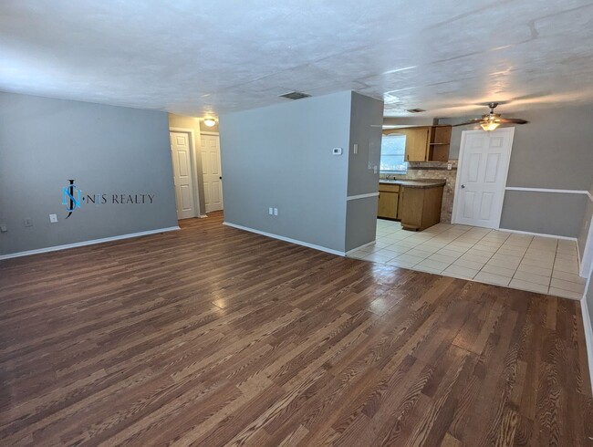 Photo - Must See 3/2/1 over 1000sf with tile/laminate floors, fresh paint, fenced yard and large living r...