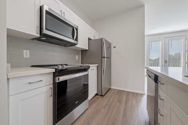 Open concept kitchen and living area - Terraces at Paseo Colorado Apartments