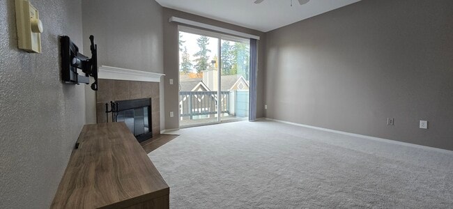 Entertainment center, TV wall mount, wood burning fireplace, balcony, living room - 3116 164th St SW