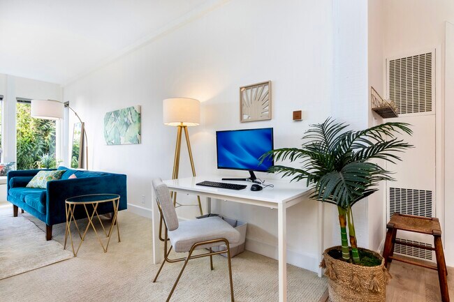 Dedicated workspace with desk, monitor, and fiber internet available up to 7 Gbps for remote work