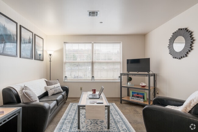 4BR, 2BA - 1,200SF - Living Room - Honeysuckle Student Apartments