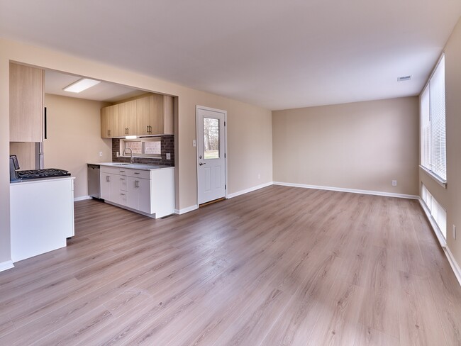Open-concept 2 Bed, 1.5 Bath with 989 sq. ft., modern kitchen finishes, and spacious living area filled with natural light.