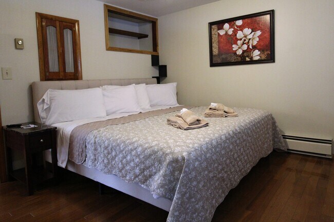 Bedroom with king size bed and hardwood floors