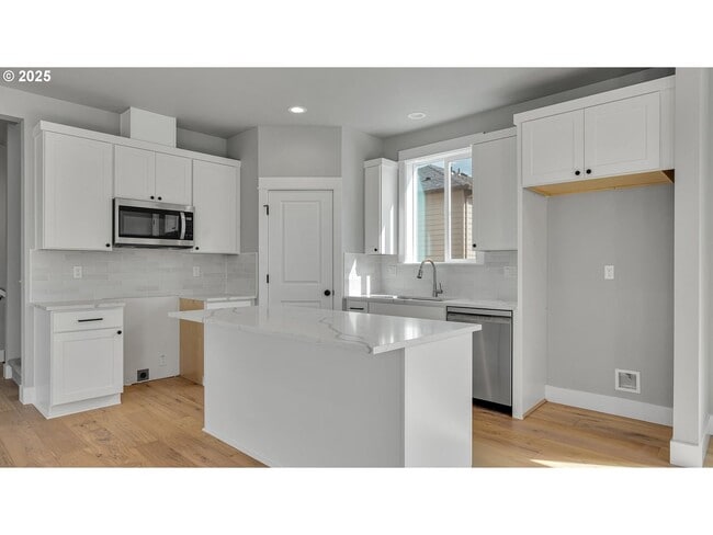 Photo - Newly Built Modern Open-Concept Condo with Island Kitchen, Granite Counters and a Deck