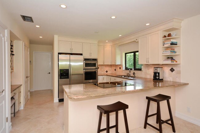 Updated kitchen with granite countertops - 4100 NW 25th Way