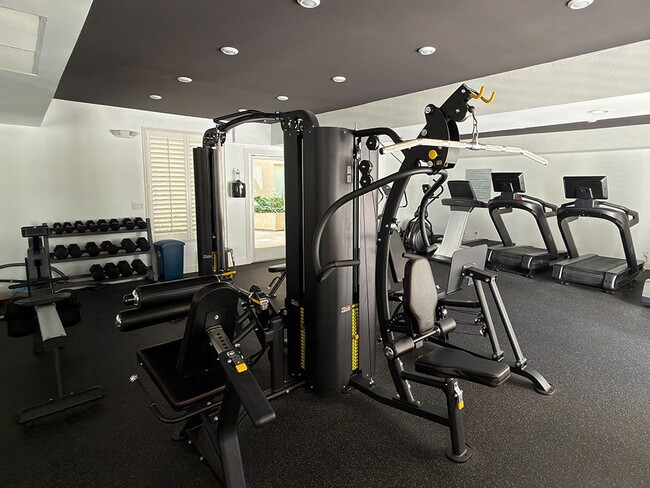 Fitness Center with Weight Machines, Treadmills, and Bikes.