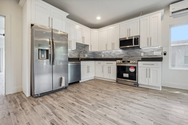 Stainless steel appliances and quartz countertops with custom cabinetry - 428 W Solidelle St Unit B