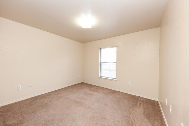 Cozy bedroom with carpet and overhead lighting