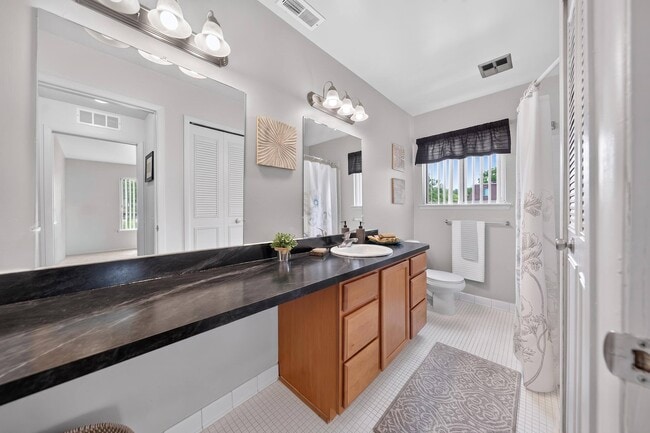 Spacious bathroom with ample storage space at Drawbridge Apartments in Harrison Township, MI.