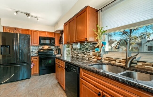 The kitchen offers a warm and inviting space designed for both everyday living and entertaining.