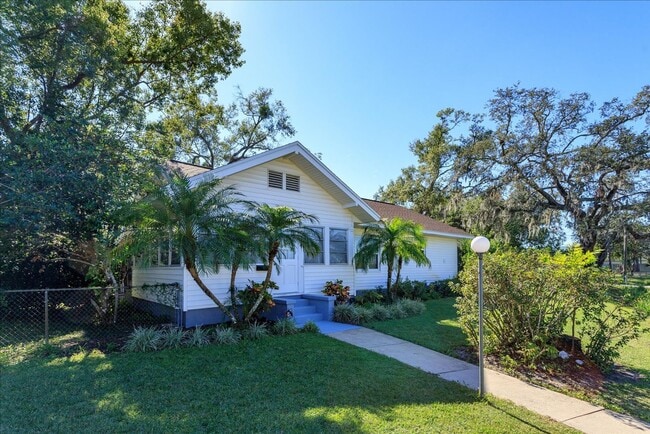 Building Photo - Run don't walk for this one of a kind beautifully maintained Old Florida Charmer on a park like d...