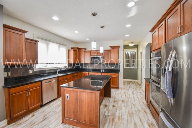 Photo - 4 Bedroom 4 Bath Executive Home in West Des Moines with a fenced in yard and a 3-car garage