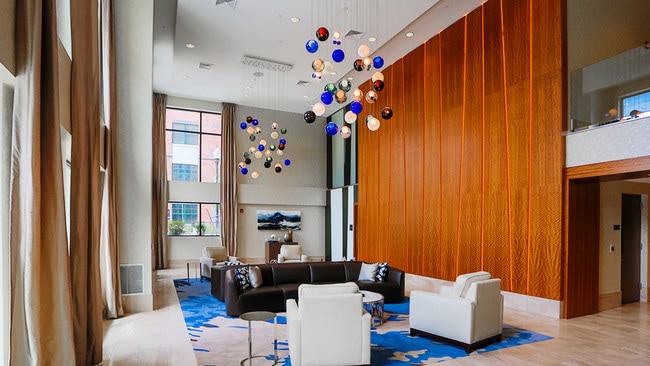 Soaring ceiling and unique light design featured in this residents lounge