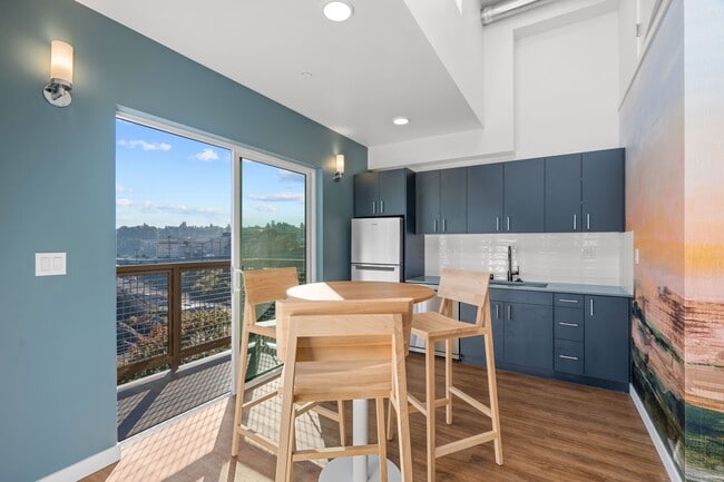 Dine in style in this elegant dining room, featuring a spacious table, comfortable chairs, and a beautiful view. - Harbor Flats